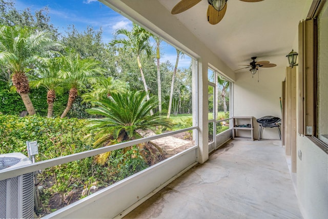 unfurnished sunroom with ceiling fan