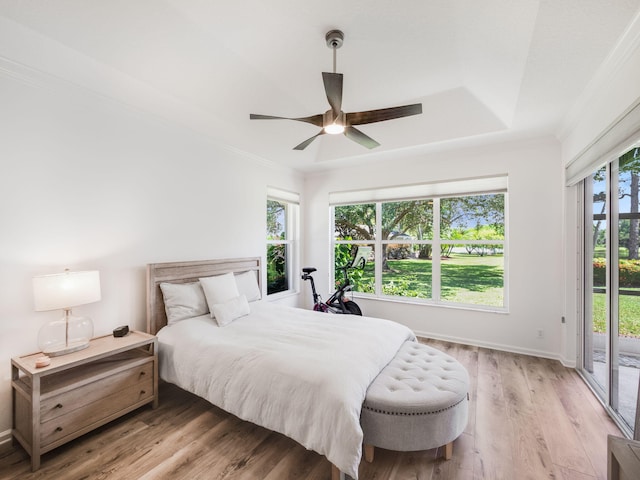 bedroom featuring access to outside, light hardwood / wood-style floors, ornamental molding, and ceiling fan