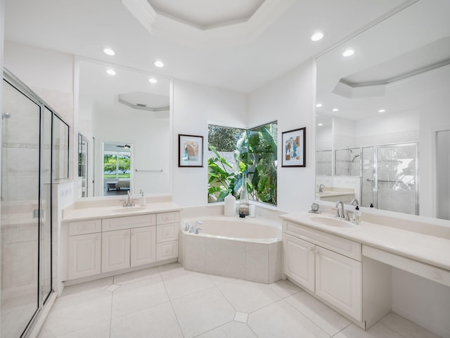 bathroom with plus walk in shower, plenty of natural light, and a raised ceiling