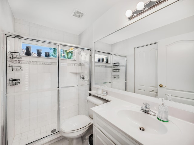 bathroom with vanity, toilet, and an enclosed shower