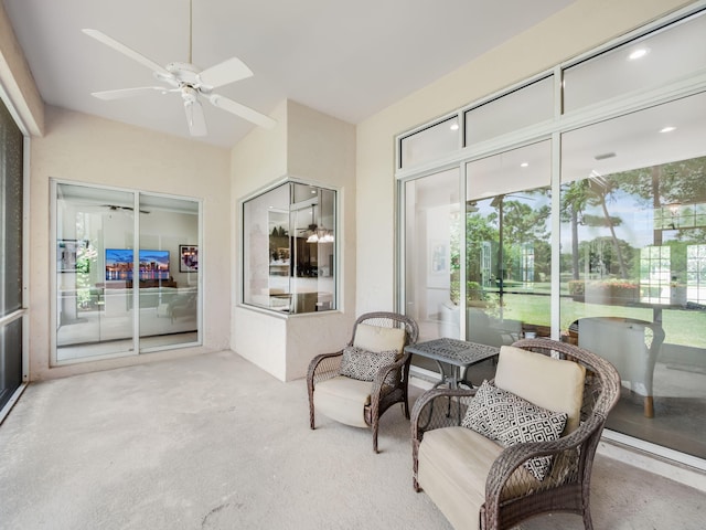 sunroom / solarium featuring ceiling fan