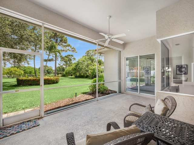 sunroom / solarium featuring ceiling fan