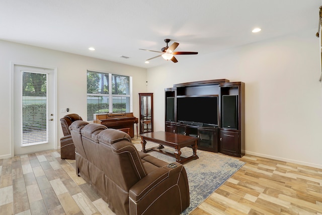 living room featuring ceiling fan and light hardwood / wood-style floors