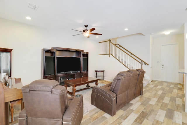 living room with light wood-type flooring and ceiling fan