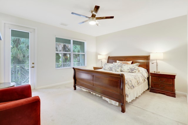 bedroom with access to exterior, ceiling fan, and light colored carpet