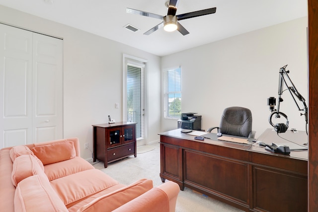 carpeted office with ceiling fan