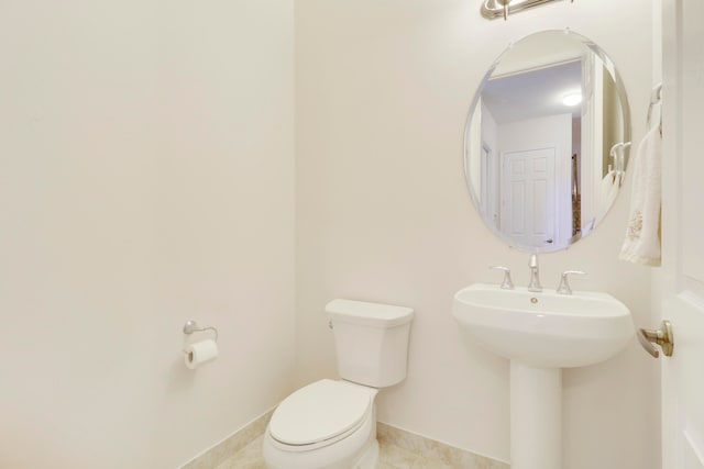 bathroom featuring sink, tile patterned flooring, and toilet