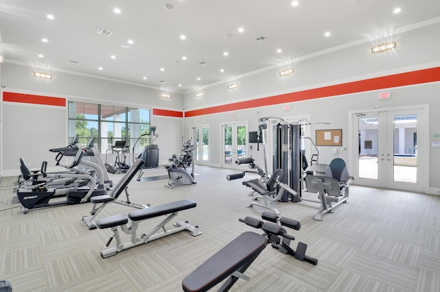 exercise room featuring light carpet, french doors, an inviting chandelier, and crown molding