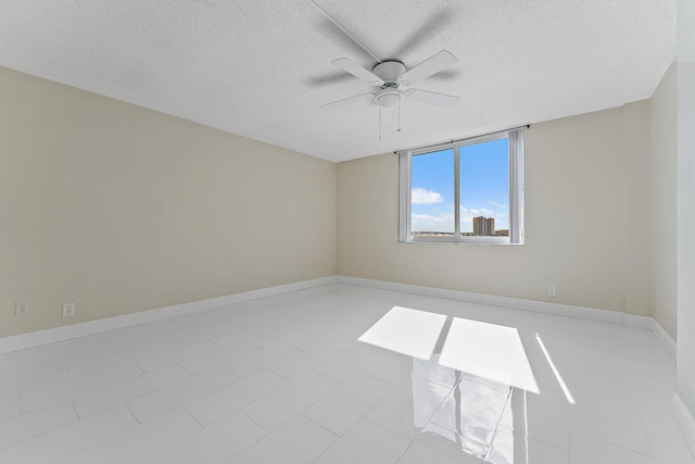 empty room featuring a textured ceiling and ceiling fan