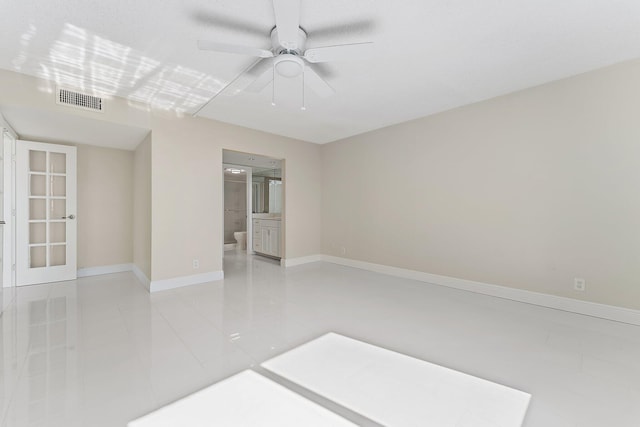 unfurnished room featuring french doors, light tile patterned floors, and ceiling fan