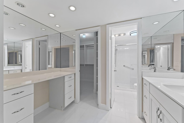 bathroom with tile patterned floors, vanity, toilet, and an enclosed shower