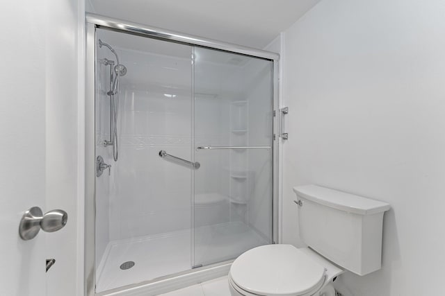 bathroom featuring toilet and an enclosed shower