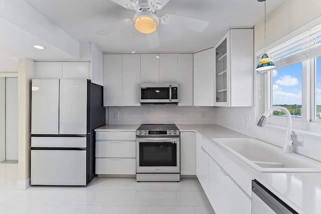 kitchen featuring white cabinetry, sink, appliances with stainless steel finishes, and tasteful backsplash