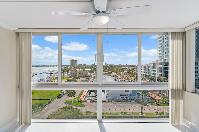 interior space with a water view and ceiling fan