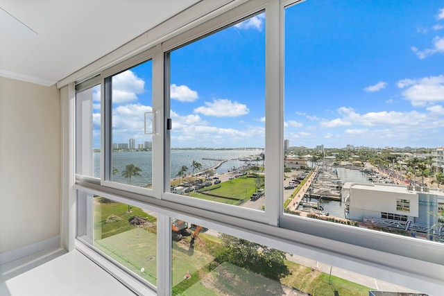 unfurnished sunroom featuring a water view