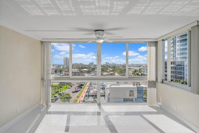 unfurnished sunroom featuring a healthy amount of sunlight and ceiling fan