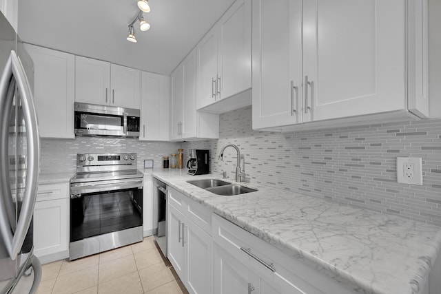 kitchen with white cabinetry, light tile patterned floors, sink, and appliances with stainless steel finishes