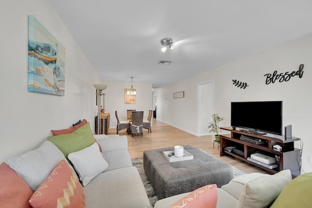 living room with a chandelier and hardwood / wood-style flooring