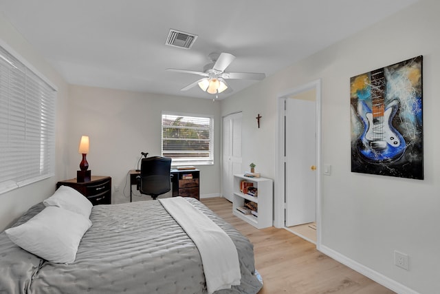 bedroom with ceiling fan and light hardwood / wood-style floors