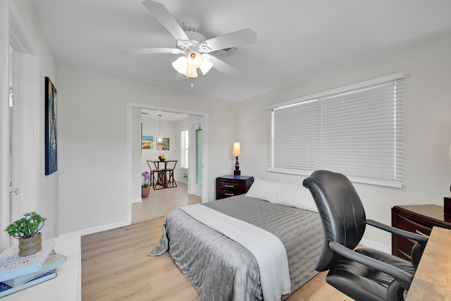 bedroom with ceiling fan and light hardwood / wood-style floors