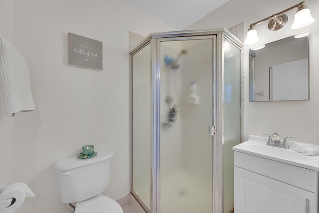 bathroom featuring vanity, toilet, and an enclosed shower