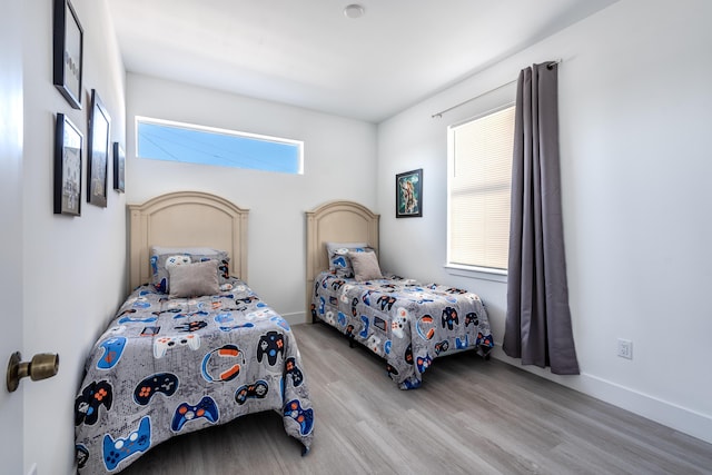 bedroom featuring wood finished floors and baseboards