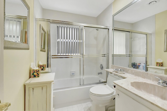 full bathroom with vanity, combined bath / shower with glass door, toilet, and tile patterned flooring