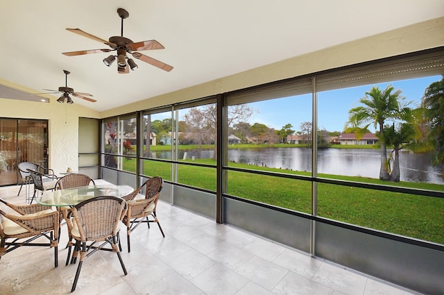 sunroom with a water view and ceiling fan