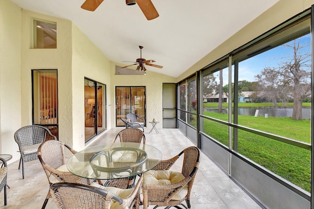 sunroom / solarium featuring a water view, ceiling fan, and lofted ceiling