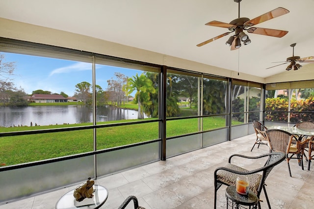 sunroom / solarium featuring vaulted ceiling, a water view, a healthy amount of sunlight, and ceiling fan