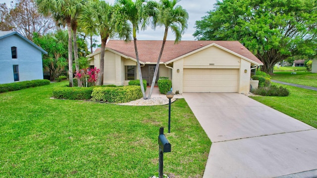 view of front facade with a garage, a front lawn, and concrete driveway