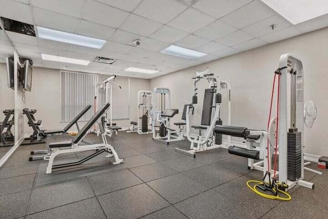 workout area with a paneled ceiling