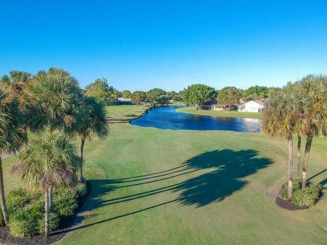 view of property's community featuring a yard and a water view