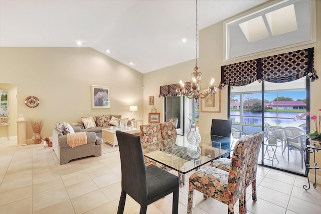 tiled dining space featuring a chandelier and high vaulted ceiling