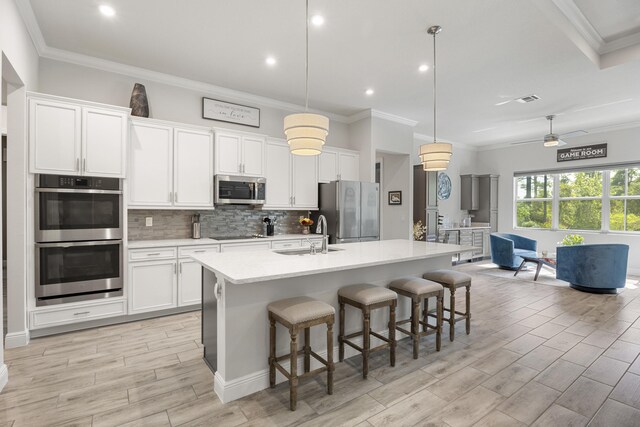 dining room featuring ornamental molding, light wood-type flooring, wine cooler, and ceiling fan