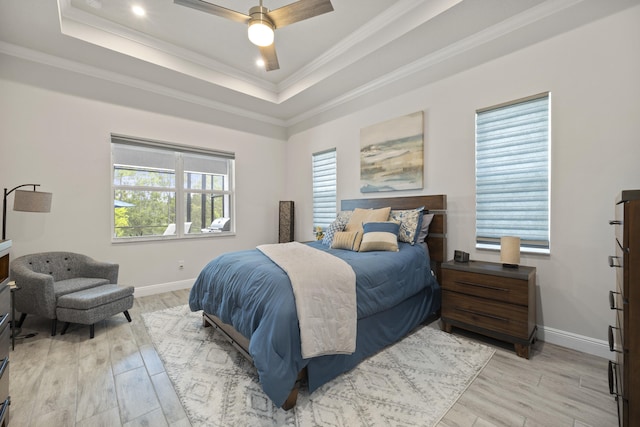 bedroom featuring ornamental molding, light wood-type flooring, multiple windows, and ceiling fan