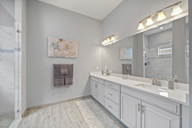 bathroom featuring a tile shower and hardwood / wood-style floors