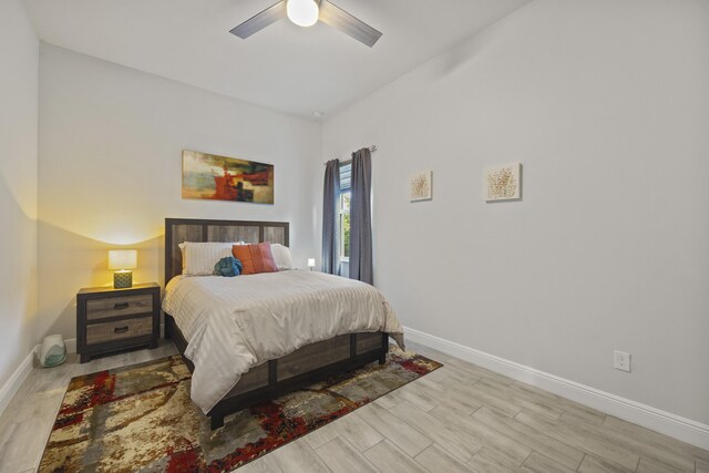 bathroom with hardwood / wood-style floors, a shower with curtain, vanity, and toilet