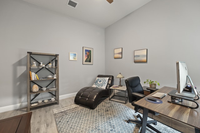 office space featuring lofted ceiling, ceiling fan, and hardwood / wood-style flooring