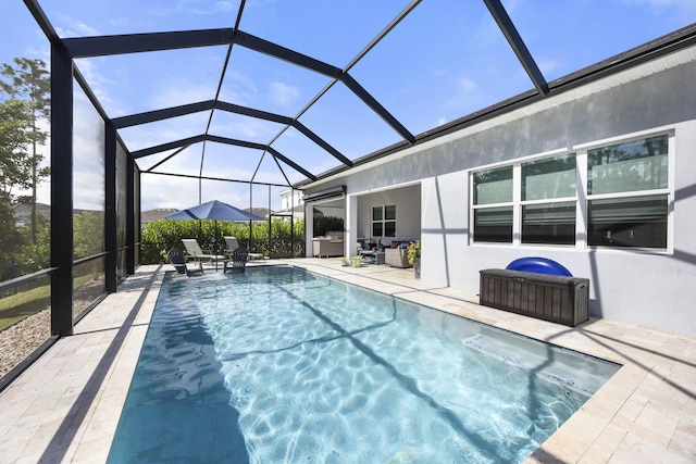 view of pool with a lanai and a patio area