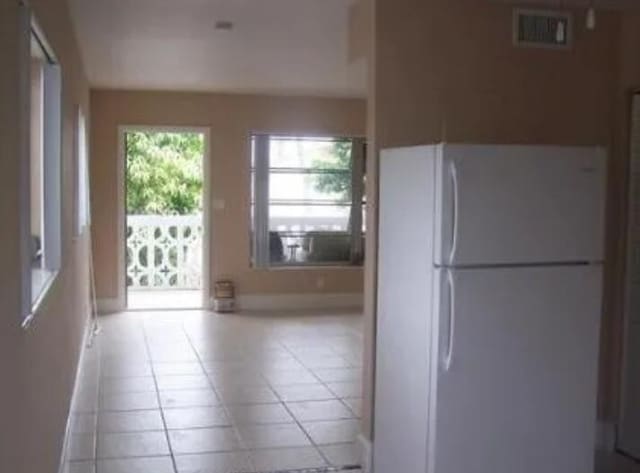 kitchen featuring white refrigerator and light tile patterned floors