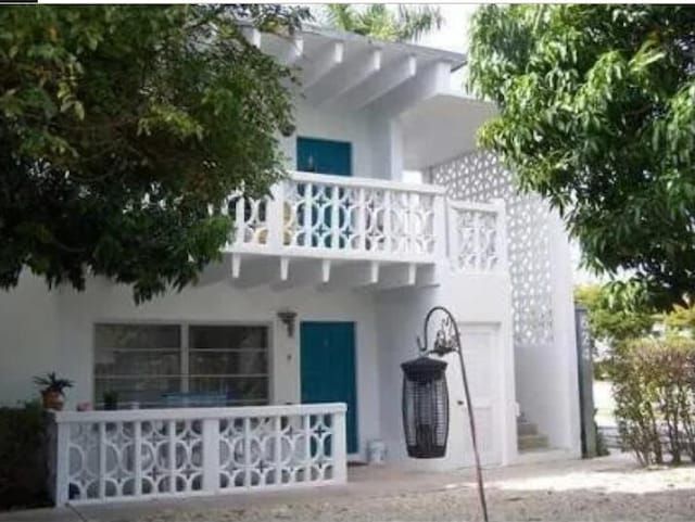 rear view of property with a balcony