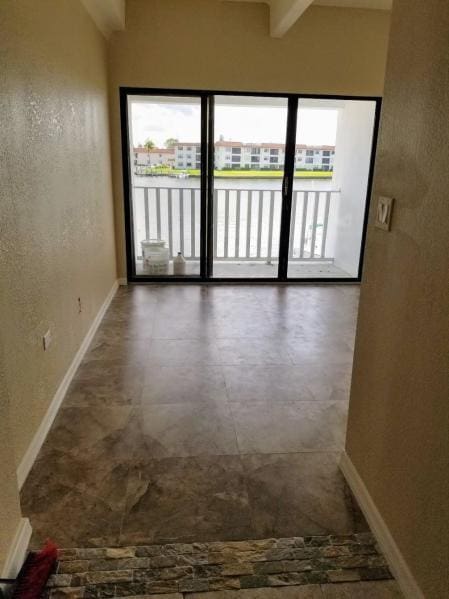 spare room featuring beamed ceiling