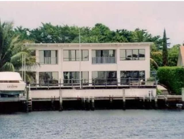 rear view of property with a water view