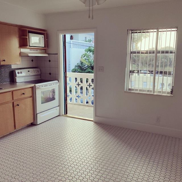 kitchen with white appliances, ventilation hood, and decorative backsplash