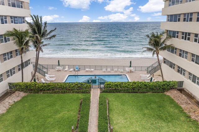 drone / aerial view featuring a view of the beach and a water view