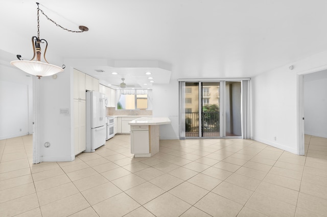 kitchen with light tile patterned floors, sink, white cabinets, white appliances, and ceiling fan