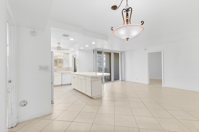 kitchen featuring light tile patterned flooring, a kitchen island, dishwasher, and decorative light fixtures