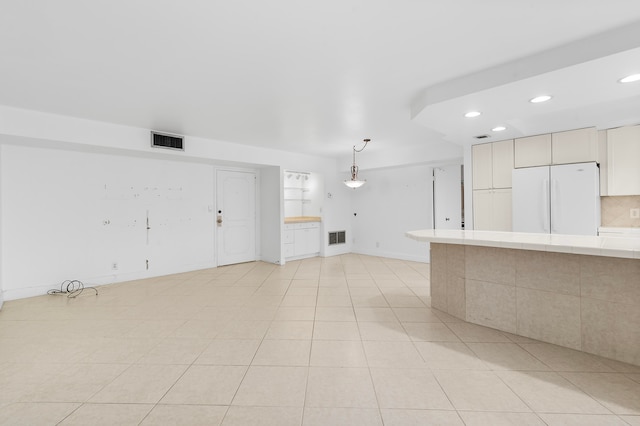 unfurnished living room featuring light tile patterned flooring