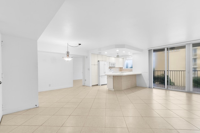 kitchen featuring light tile patterned flooring, decorative light fixtures, white appliances, white cabinets, and kitchen peninsula